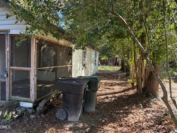 a view of a porch with wooden floor and a yard