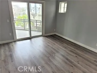 a view of wooden floor and windows in a room