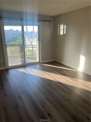 a view of room with window and wooden floor