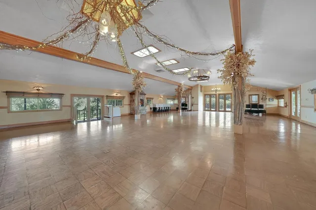 a view of a yard with plants and wooden fence