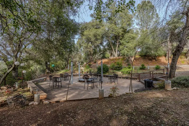 a bathroom with a tub a mirror and shower