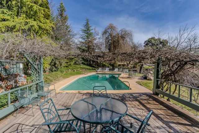 a living room with furniture a flat screen tv and a table