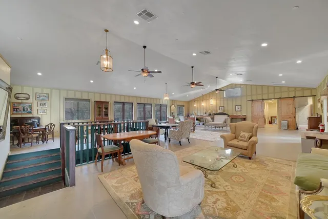 a bathroom with a shower a mirror and a sink