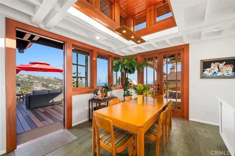 a view of a dining room with furniture and a kitchen