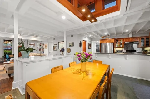 a dining table with chairs and wooden floor