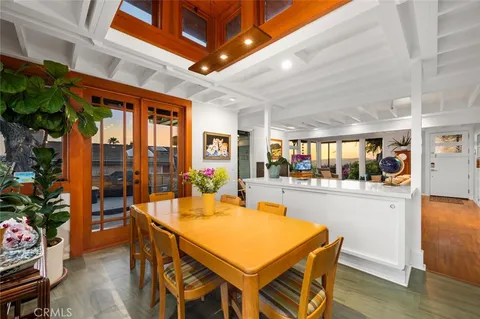 a view of a dining room with furniture large windows and wooden floor