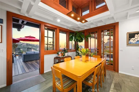a large white kitchen with lots of counter space and glass table