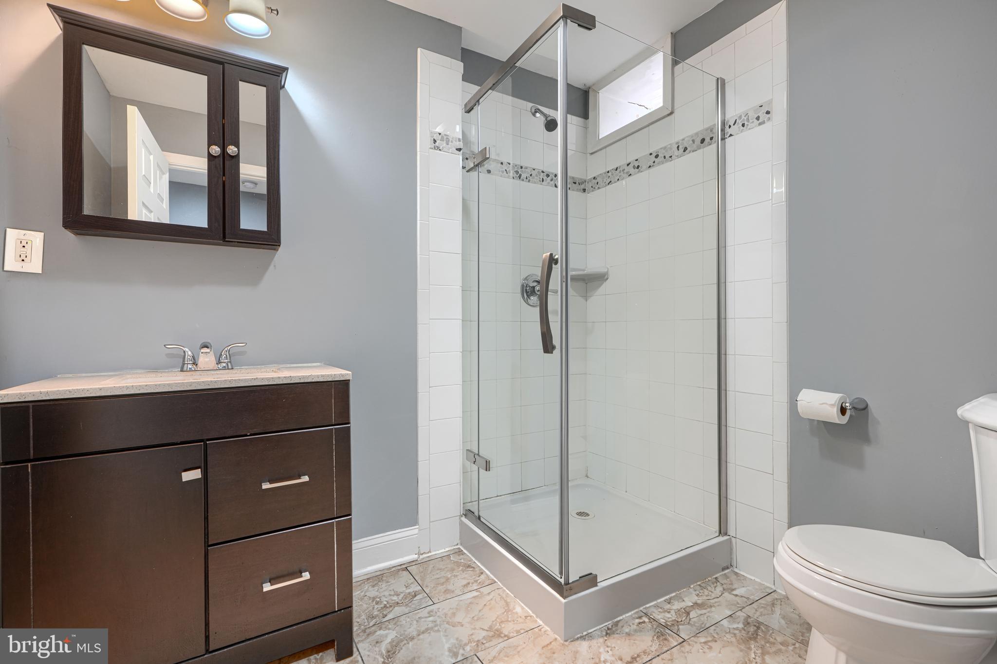 1106 Battery Avenue Baltimore, MD 21230 - Photo 20 of 36 a bathroom with a toilet a sink and shower