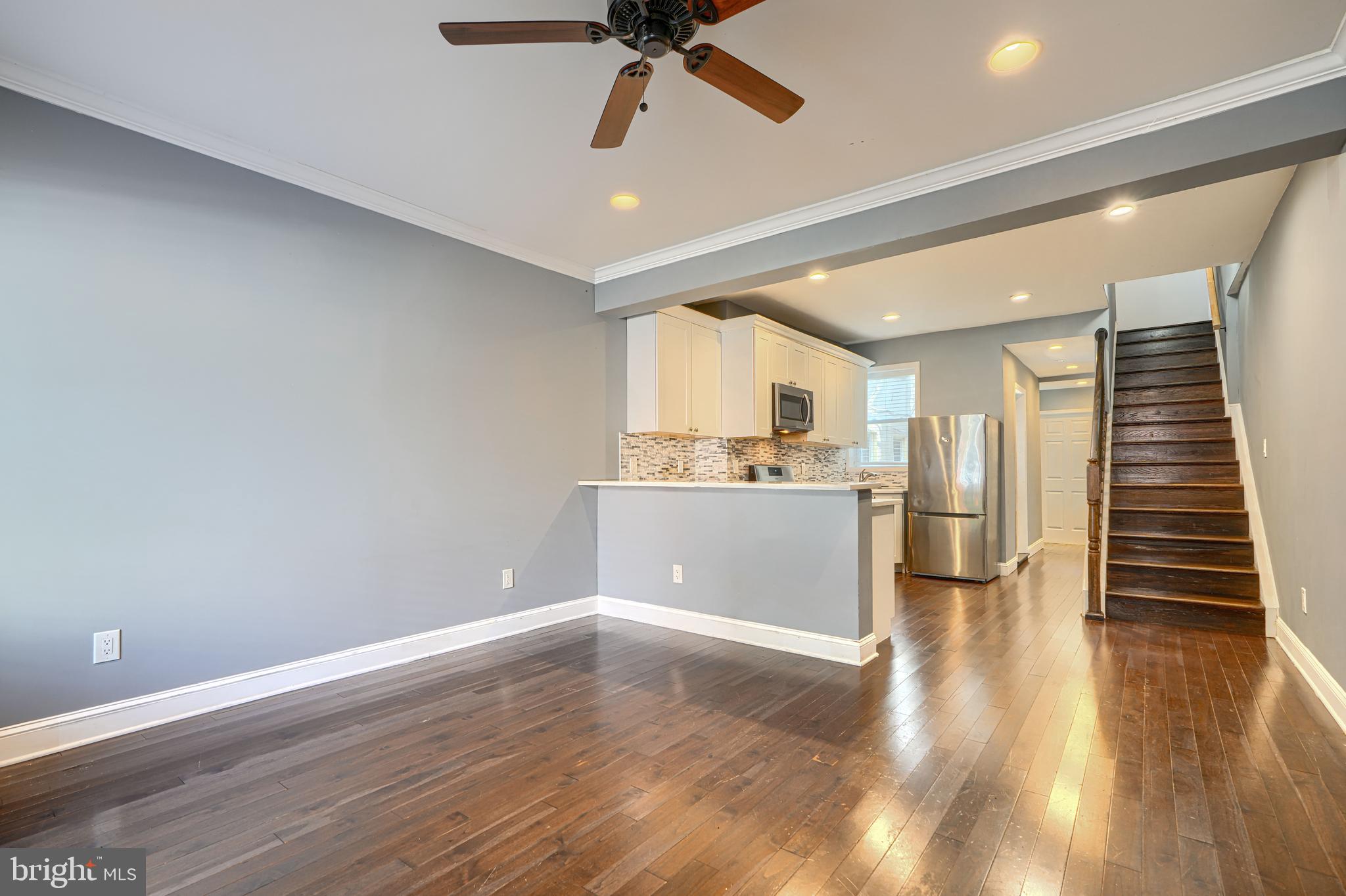 1106 Battery Avenue Baltimore, MD 21230 - Photo 3 of 36 a view of a hallway with wooden floor and a kitchen