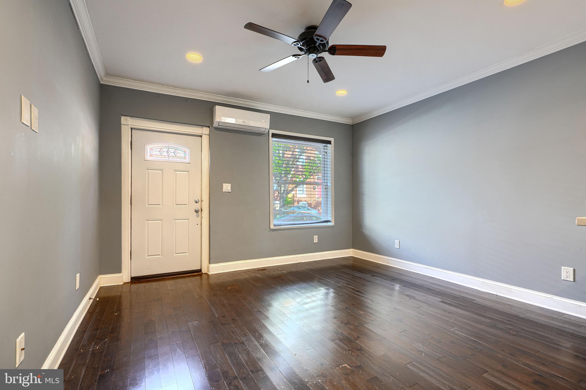 1106 Battery Avenue Baltimore, MD 21230 - Photo 4 of 36 a view of an empty room with window and wooden floor