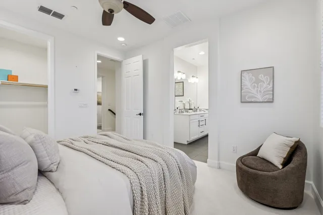 a spacious bedroom with a bed and couch