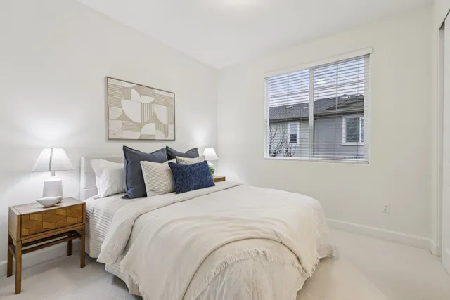 a bedroom with bed and a night stand