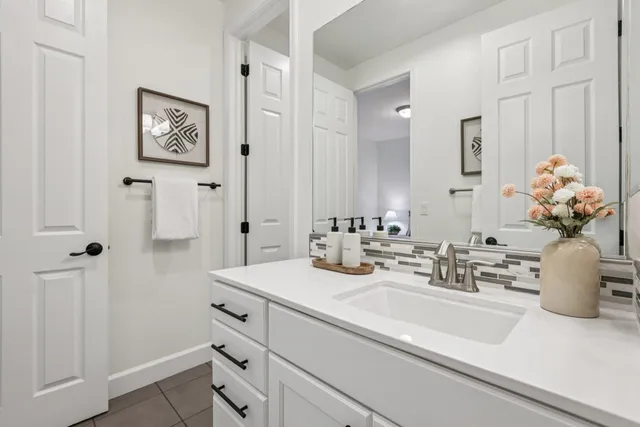 a bathroom with a sink a vanity and a mirror