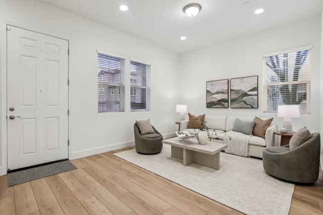 a living room with furniture potted plant and window