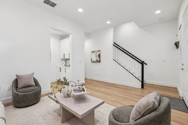 a living room with furniture and a potted plant