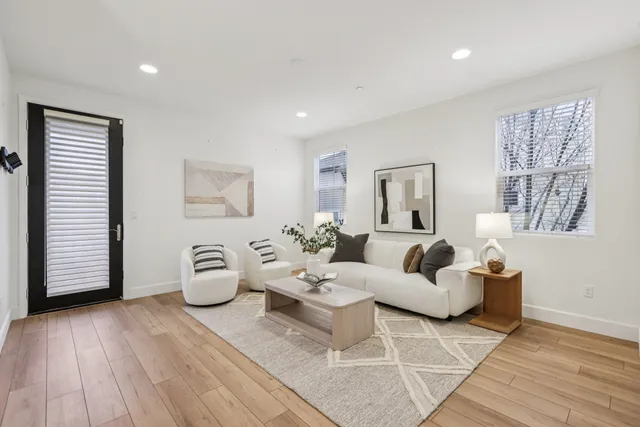 a living room with furniture and wooden floor