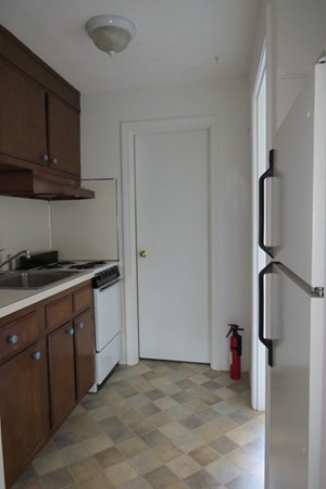 31 Liberty Square Road, Unit D Boxborough, MA 01719 - Photo 2 of 9 a kitchen with stainless steel appliances granite countertop a refrigerator and a stove top oven
