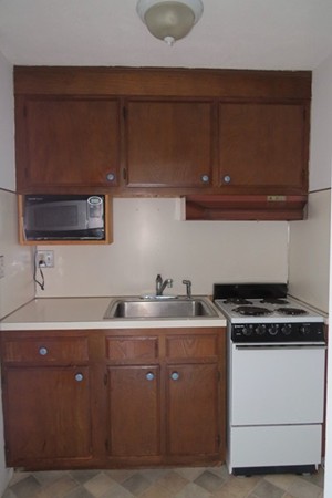 31 Liberty Square Road, Unit D Boxborough, MA 01719 - Photo 3 of 9 a kitchen with a sink and cabinets