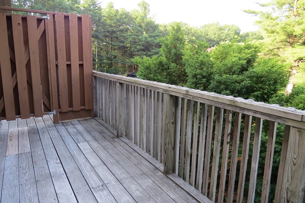 31 Liberty Square Road, Unit D Boxborough, MA 01719 - Photo 9 of 9 a view of wooden balcony with trees