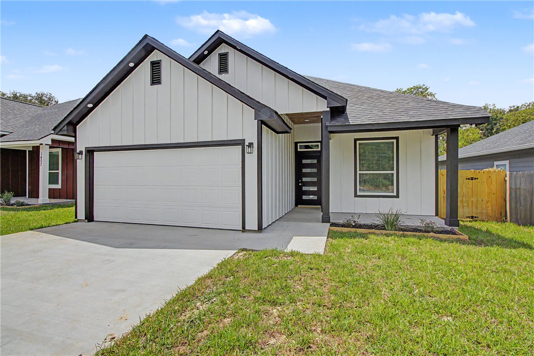 1403 Rochester Street Bryan, TX 77803 - Photo 1 of 20 Modern farmhouse exterior with white vertical siding, black trim accents, a single-car garage, and a covered entry