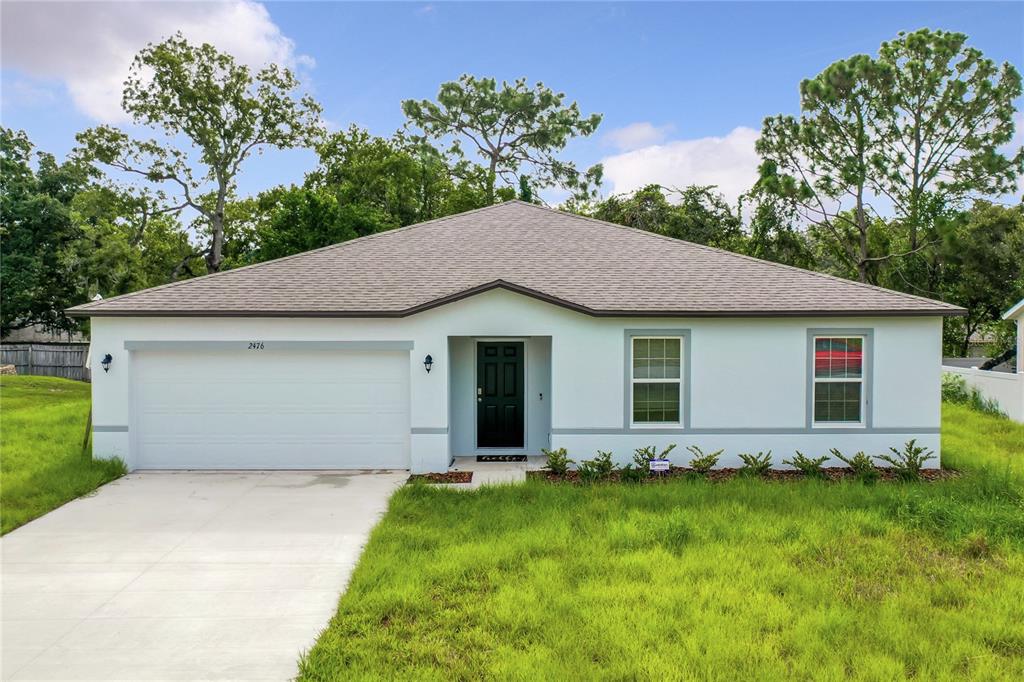2476 Amherst Avenue Spring Hill, FL 34609 - Photo 1 of 1 a view of a house with backyard and garden