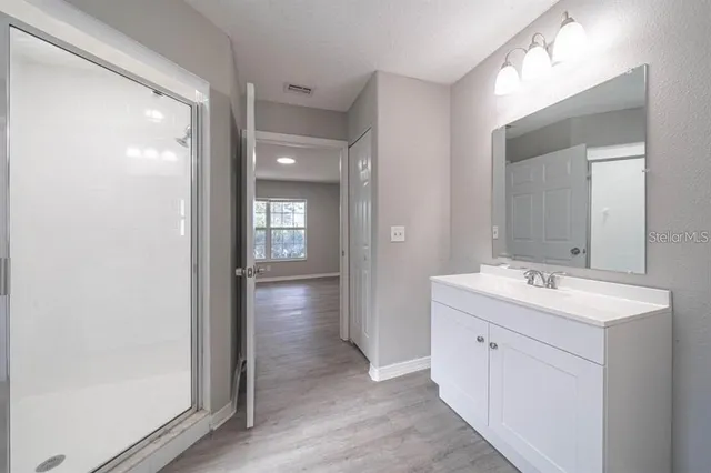 a bathroom with a double vanity sink and mirror