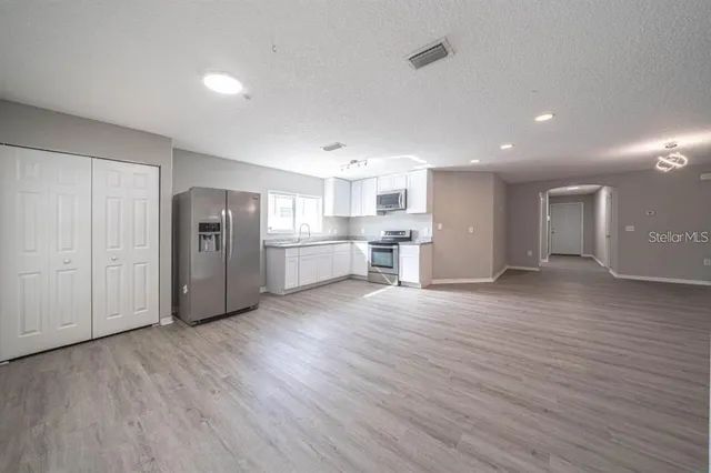 a view of kitchen with stainless steel appliances refrigerator microwave and stove