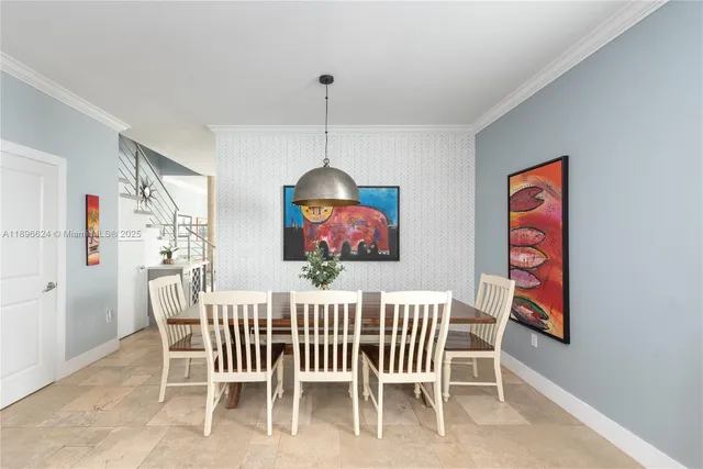 a dining room with furniture a chandelier and window