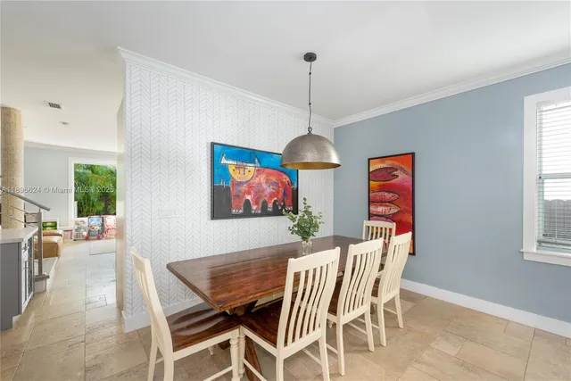 a dining room with furniture a chandelier and window