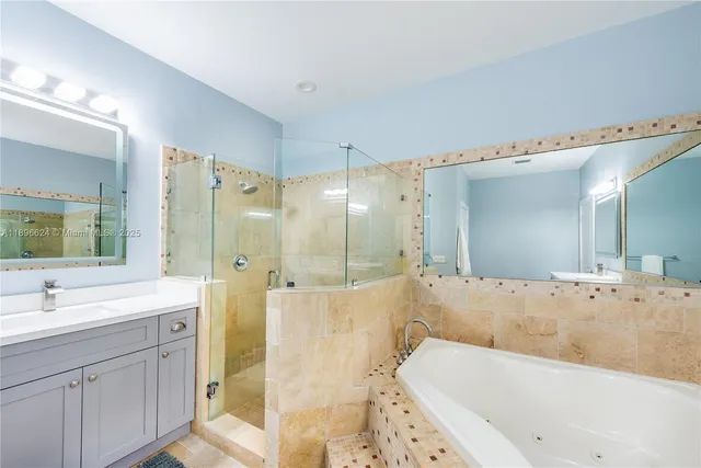 a bathroom with a tub a sink shower and mirror