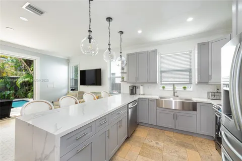 a kitchen with a sink stove and refrigerator