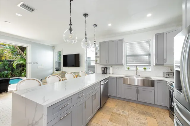 a kitchen with a sink stove and refrigerator