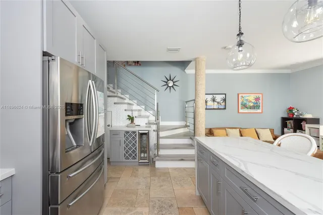 a kitchen with stainless steel appliances granite countertop a refrigerator and a sink