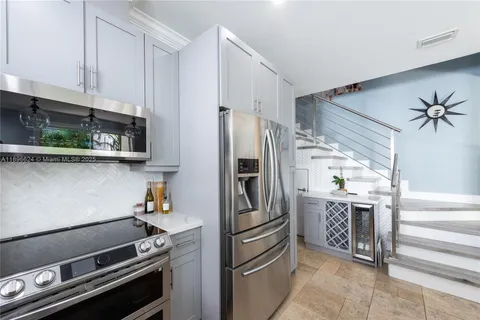 a kitchen with stainless steel appliances a refrigerator and a stove