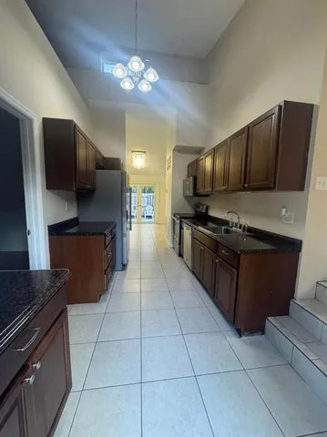 a kitchen with stainless steel appliances granite countertop a stove and a refrigerator