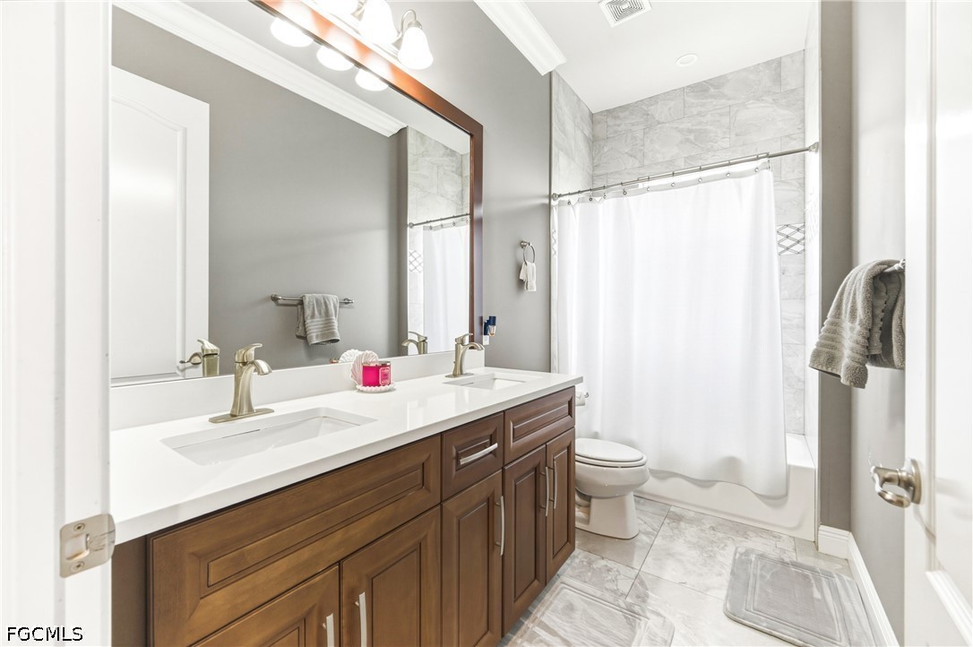 1700 43rd Terrace Southwest Naples, FL 34116 - Photo 13 of 38 a bathroom with a double vanity sink toilet and shower