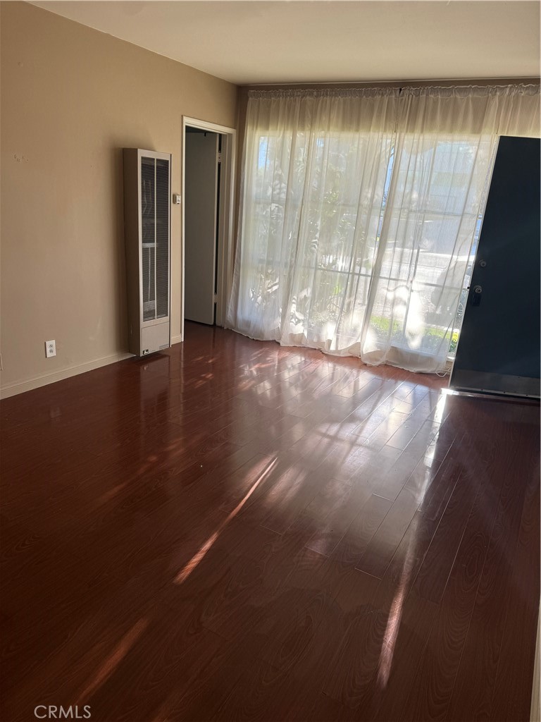 285 Garfield Avenue, Unit 3B Pasadena, CA 91101 - Photo 2 of 8 an empty room with wooden floor and windows