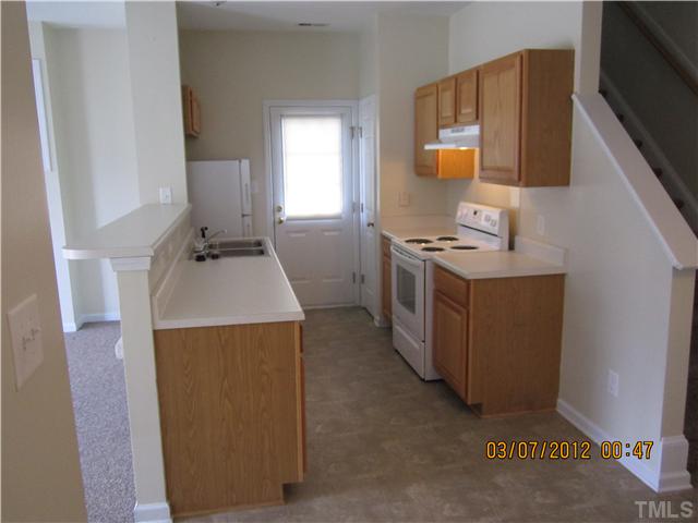 5844 Forest Point Road Raleigh, NC 27610 - Photo 2 of 4 a kitchen with a stove a sink and a refrigerator