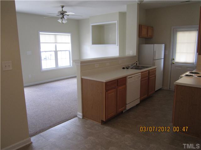5844 Forest Point Road Raleigh, NC 27610 - Photo 3 of 4 a kitchen with a stove and a refrigerator