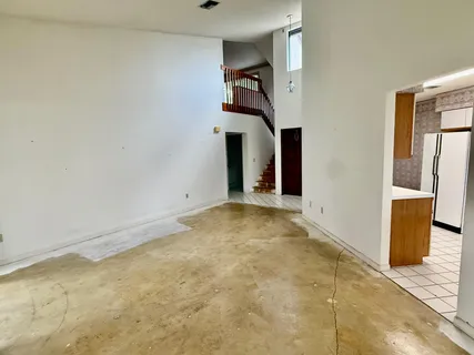 a view of a big room with closet and windows