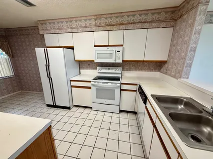 a kitchen with a stove a sink and a refrigerator