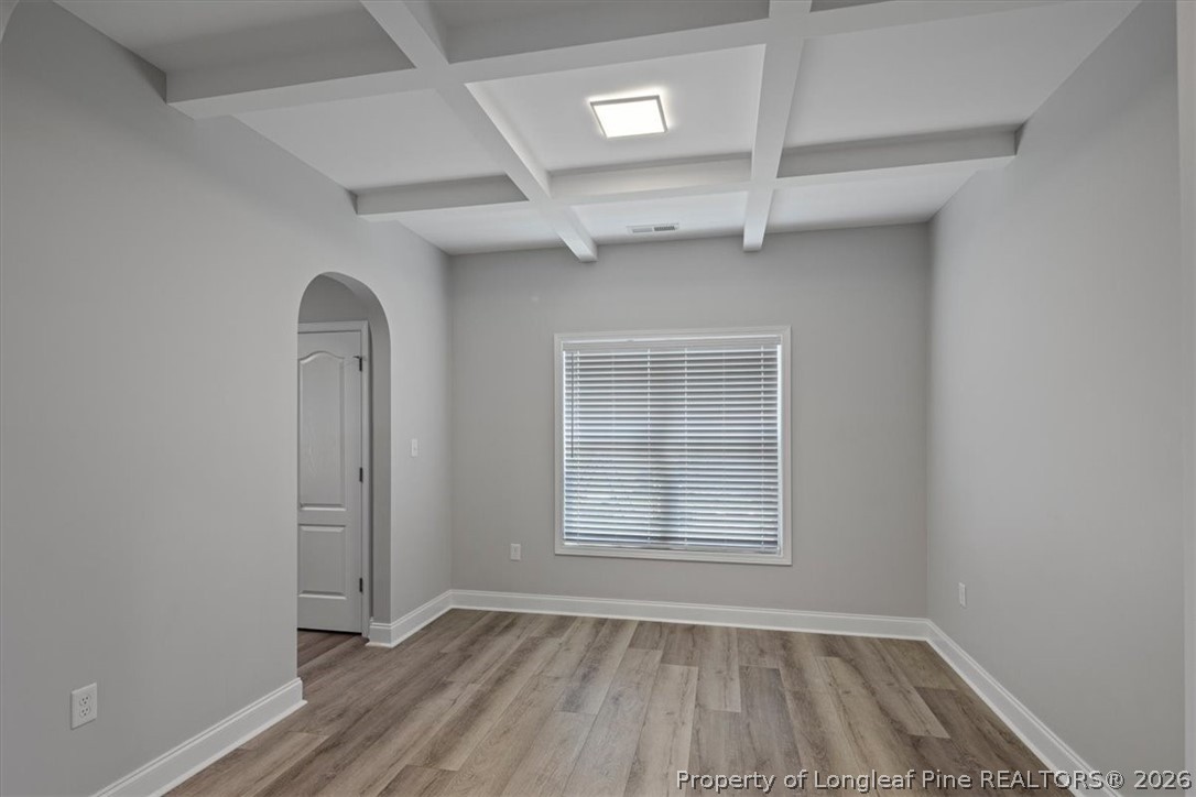 134 Huzzas Circle Cameron, NC 28326 - Photo 5 of 31 an empty room with wooden floor cabinet and windows