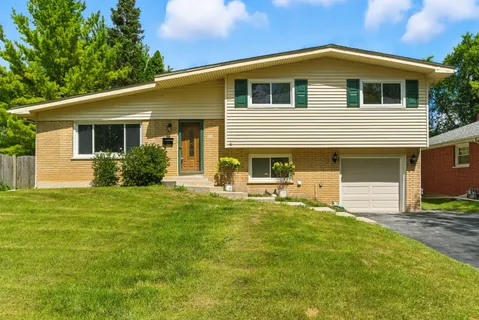 a front view of house with yard and outdoor seating