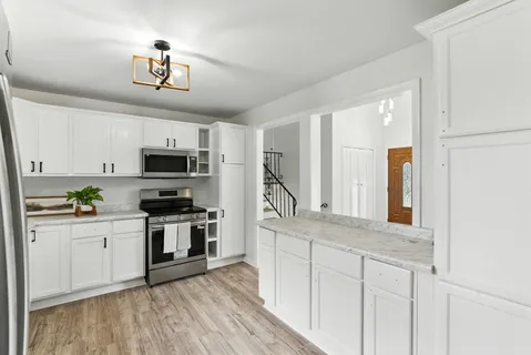 a kitchen with stainless steel appliances granite countertop a stove and a sink