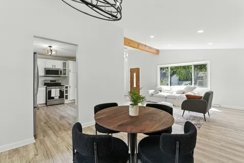 a dining room with furniture and window