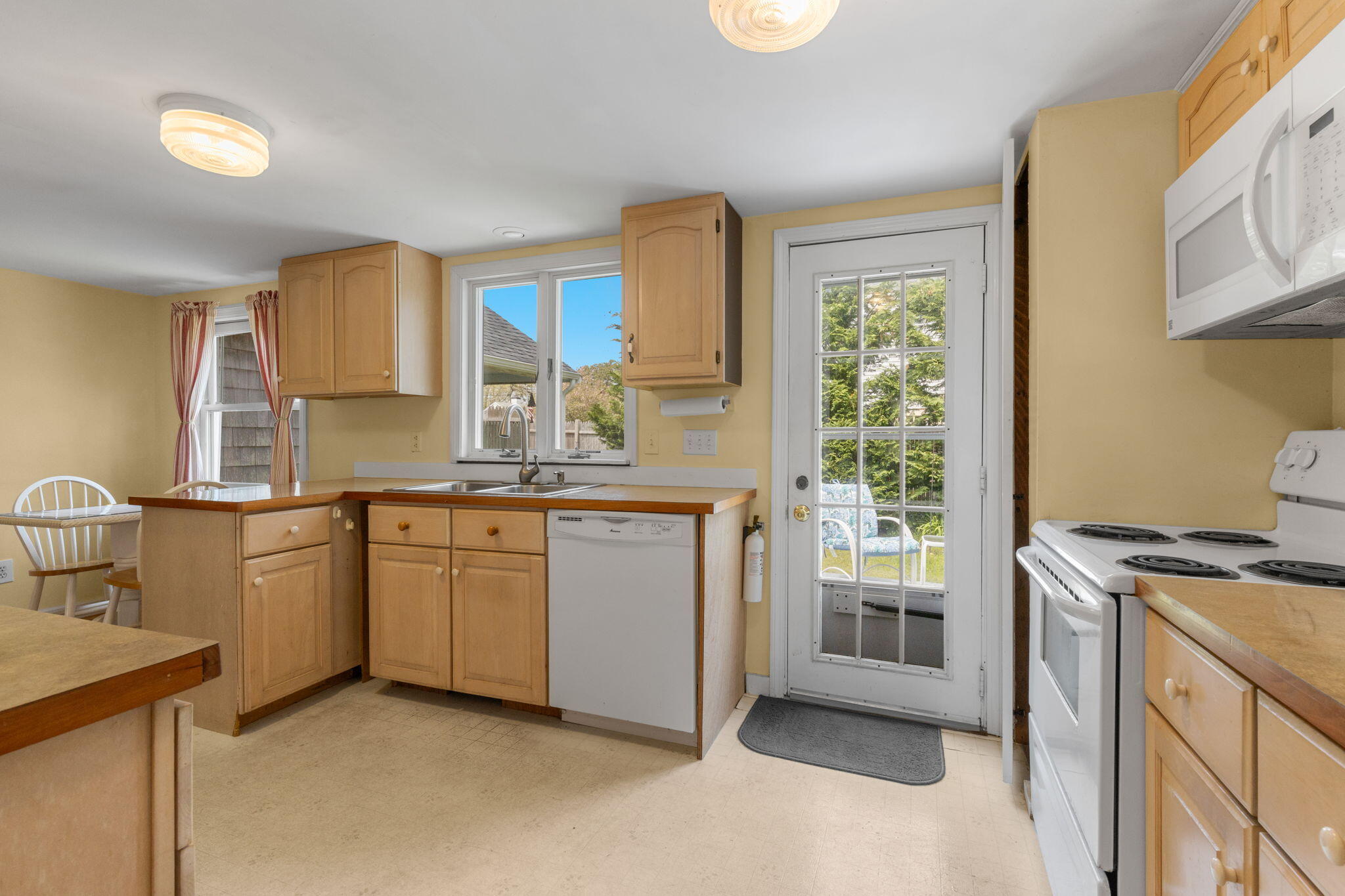 7 Aunt Matties Road Chatham, MA 02633 - Photo 16 of 37 a kitchen with granite countertop a sink stove and cabinets
