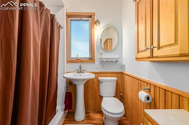 a bathroom with a toilet a sink and a window