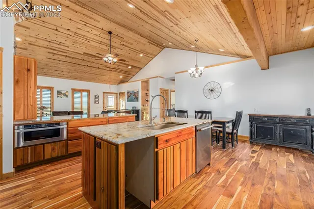 a kitchen with a stove a counter space and wooden floor