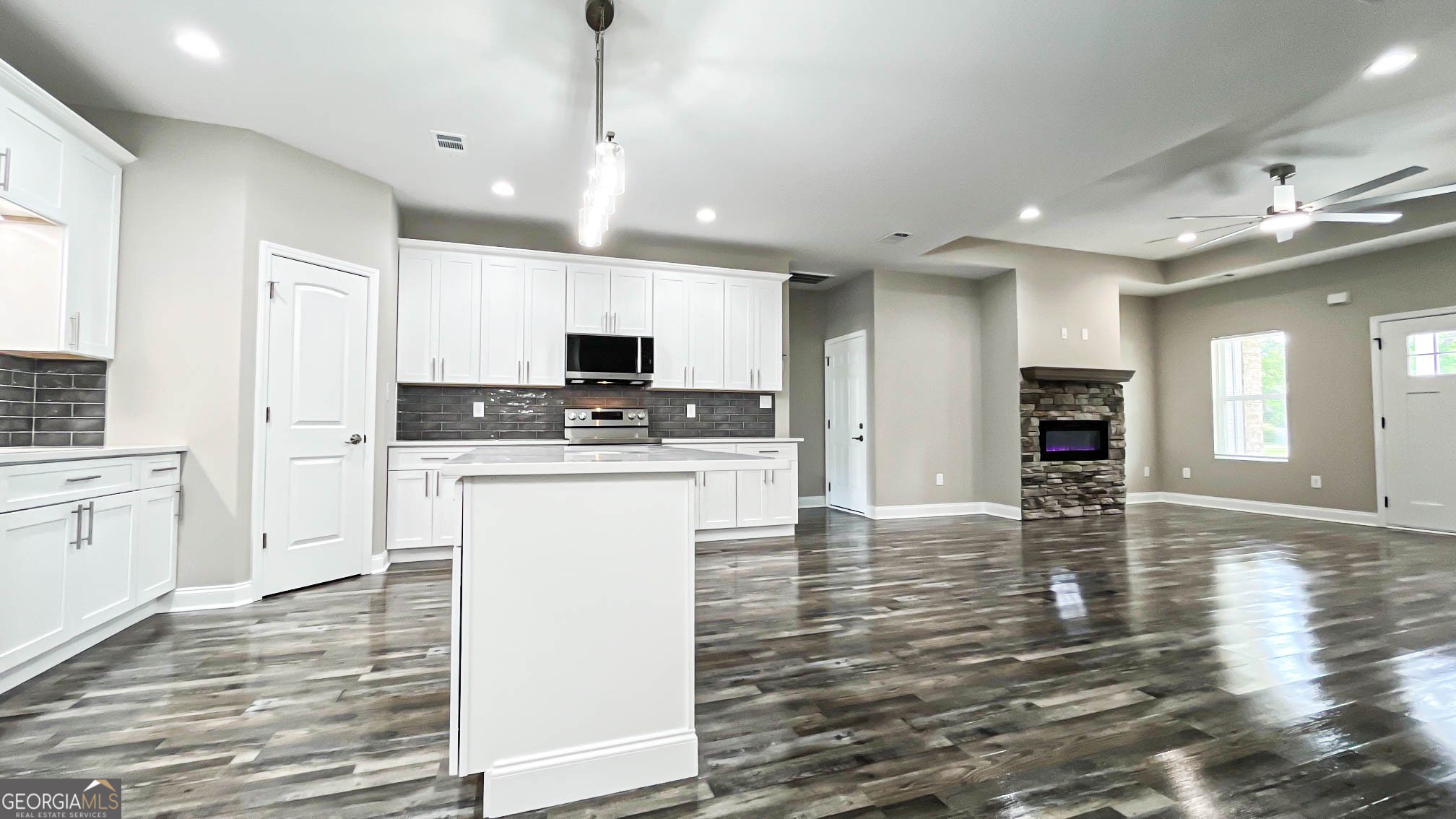 2011 Griffin Road Macon, GA 31216 - Photo 19 of 64 a kitchen with granite countertop a stove a sink and a refrigerator