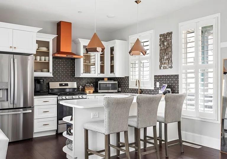 1905 Galt Cmns Kennesaw, GA 30144 - Photo 4 of 28 a kitchen with stainless steel appliances granite countertop a stove a refrigerator a dining table and chairs